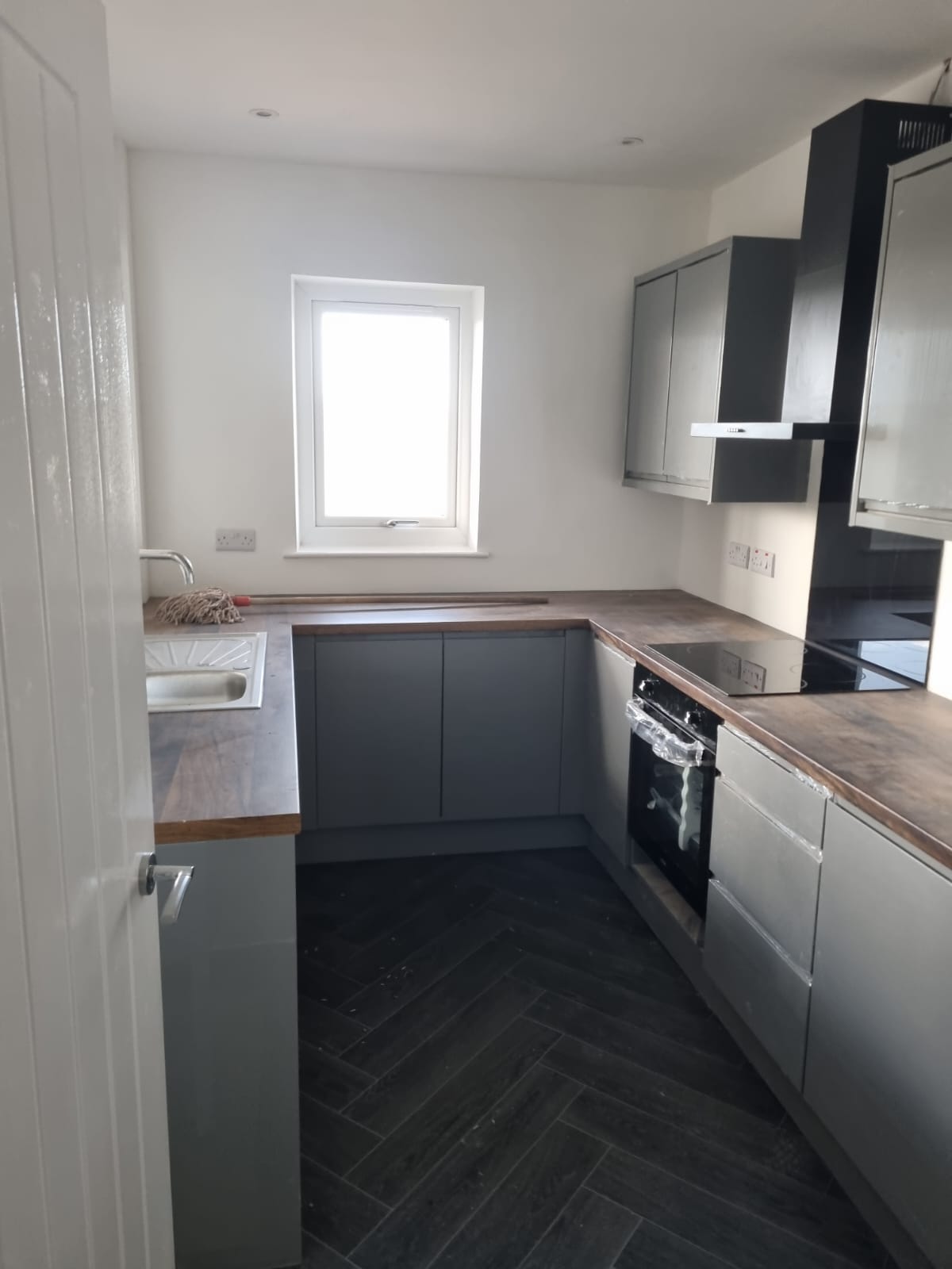 Grey Gloss Kitchen with Herringbone Floor